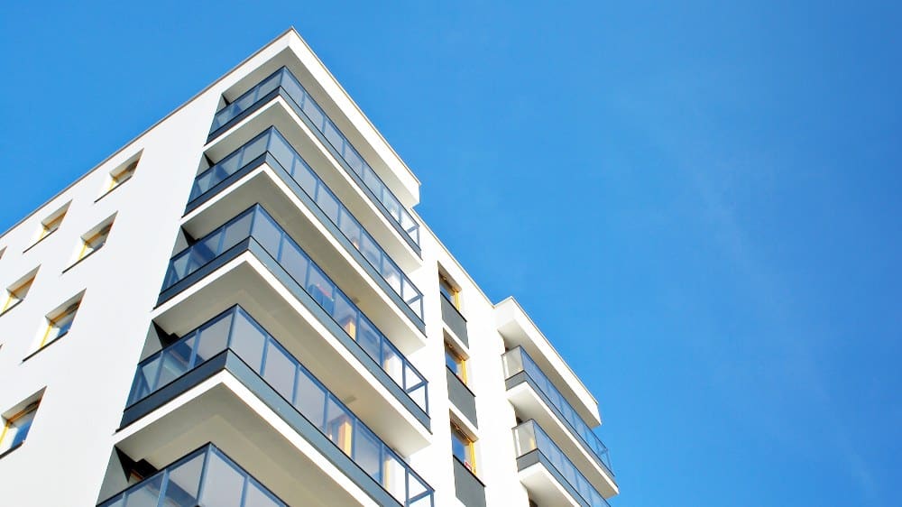 Building with blue sky in background - intelligent multifamily proptech