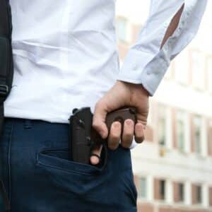 Gun threat - gun in pocket of man