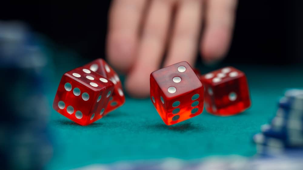 Person rolling dice at casino