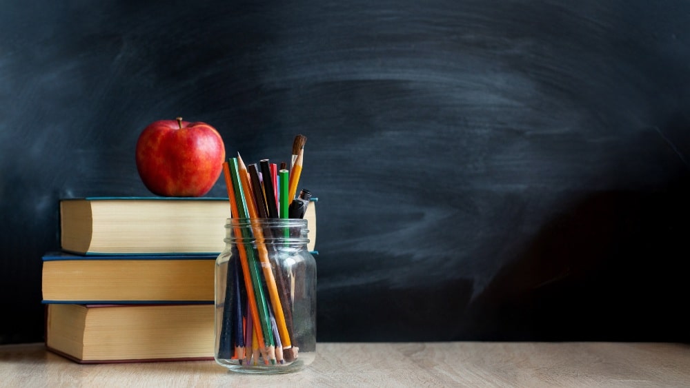 School blackboard and books